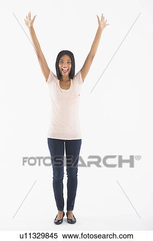 Portrait of woman with arms up, studio shot View Large Photo Image Stock Photography - Portrait of woman with arms up, studio shot. Fotosearch