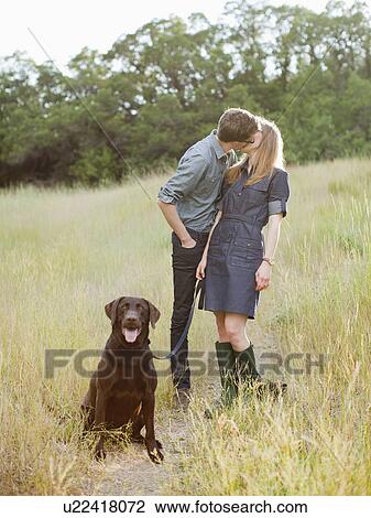 Portrait of young couple with dog View Large Photo Image Stock Image - Portrait of young couple with dog. Fotosearch