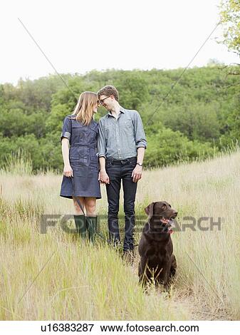 Portrait of young couple with dog View Large Photo Image Stock Photo - Portrait of young couple with dog. Fotosearch