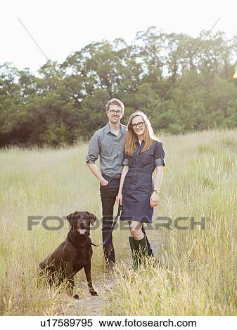 Portrait of young couple with dog View Large Photo Image Stock Photography - Portrait of young couple with dog. Fotosearch