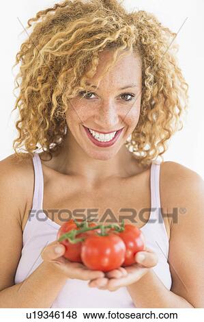 Portrait of young woman holding tomatoes View Large Photo Image Stock Photo - Portrait of young woman holding tomatoes. Fotosearch