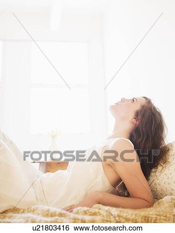 Stock Photograph - Portrait of young woman in white chemise. Fotosearch