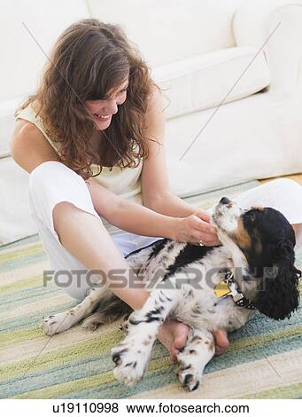 Portrait of young woman playing with dog View Large Photo Image Stock Photo - Portrait of young woman playing with dog. Fotosearch