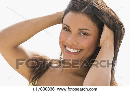 Stock Photograph - Portrait of young woman smiling. Fotosearch