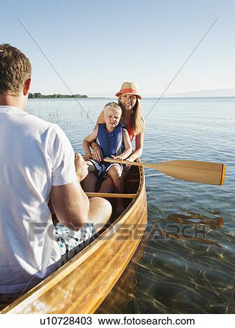 Stock Image - Portrait of young woman with son (4-5) canoe traveling. Fotosearch