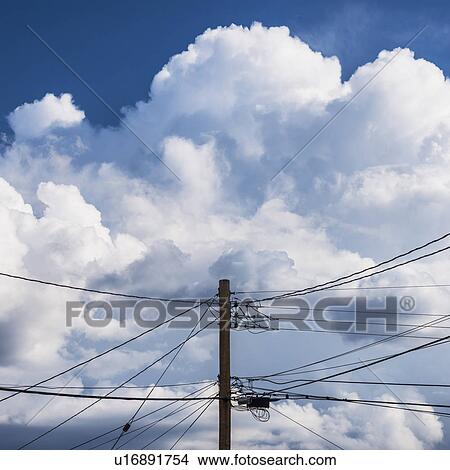 Picture - Power lines against cloudy sky. Fotosearch