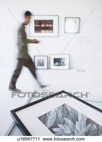 Preparations for new exhibitions in gallery with member of staff moving in background View Large Photo Image Stock Image - Preparations for new exhibitions in gallery with member of staff moving in background. Fotosearch