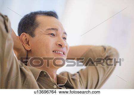 Profile of happy mid adult man with hands behind his back View Large Photo Image Picture - Profile of happy mid adult man with hands behind his back. Fotosearch
