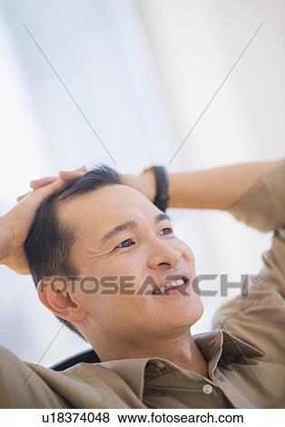 Profile of happy mid adult man with hands behind his back View Large Photo Image Stock Photo - Profile of happy mid adult man with hands behind his back. Fotosearch
