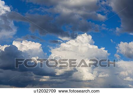 Stock Photo - Puffy clouds on sky. Fotosearch