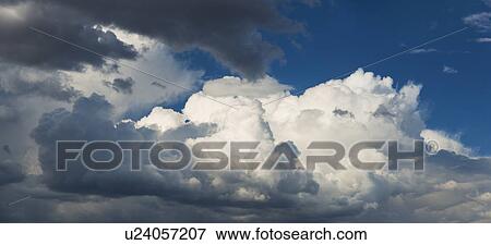 Stock Photo - Puffy clouds on sky. Fotosearch