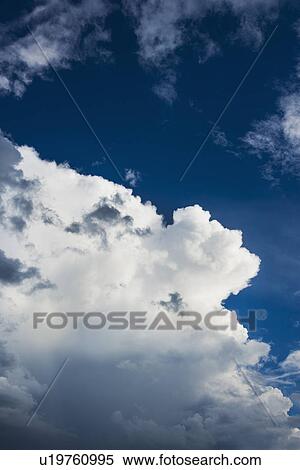 Stock Photography - Puffy clouds on sky. Fotosearch