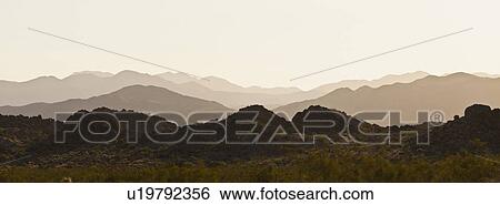 Several mountain ranges backlit by morning sun View Large Photo Image Stock Photograph - Several mountain ranges backlit by morning sun. Fotosearch