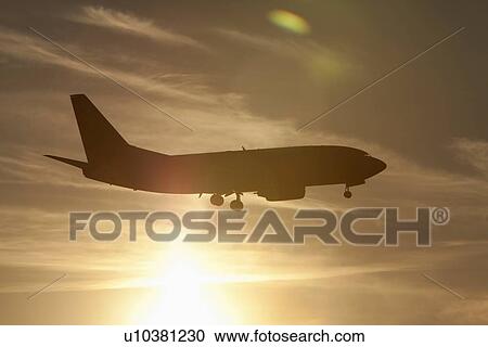 Silhouette of commercial jet flying View Large Photo Image Stock Image - Silhouette of commercial jet flying. Fotosearch