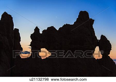 Silhouette of rock at dusk View Large Photo Image Stock Photo - Silhouette of rock at dusk. Fotosearch