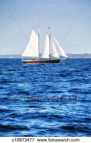Small yacht sailing on blue sea View Large Photo Image Stock Photo - Small yacht sailing on blue sea. Fotosearch