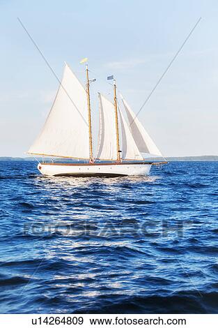 Small yacht sailing on blue sea View Large Photo Image Stock Photo - Small yacht sailing on blue sea. Fotosearch