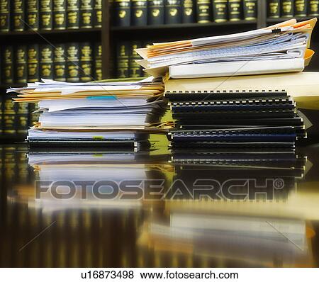 Stack of books and files on table View Large Photo Image Stock Photo - Stack of books and files on table. Fotosearch
