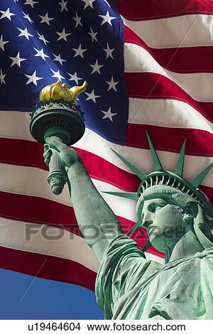 Picture - Statue of liberty under US flag. Fotosearch