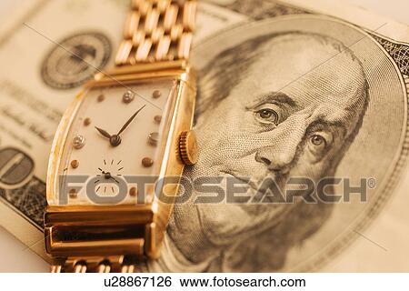 Studio shot of banknote and gold watch View Large Photo Image Stock Photograph - Studio shot of banknote and gold watch. Fotosearch