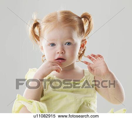 Stock Photography - Studio shot of Beautiful Redhead toddler girl looking at camera. Fotosearch