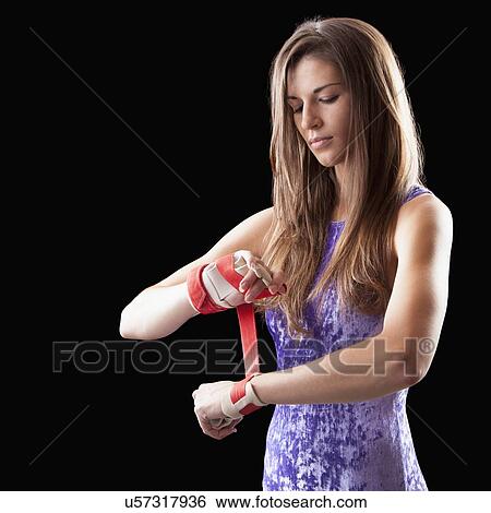 Studio shot of gymnast putting grips onto hands View Large Photo Image Stock Photograph - Studio shot of gymnast putting grips onto hands. Fotosearch