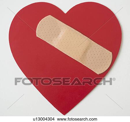 Picture - Studio shot of heart with adhesive bandage. Fotosearch