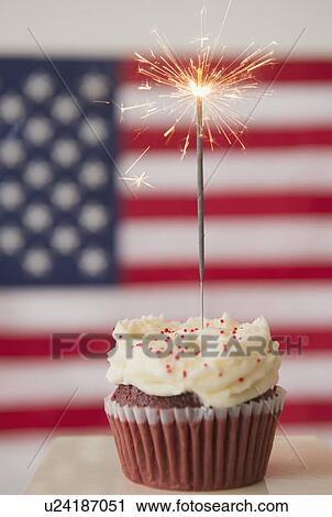 Studio shot of sparkler atop cupcake, american flag in background View Large Photo Image Stock Image - Studio shot of sparkler atop cupcake, american flag in background. Fotosearch