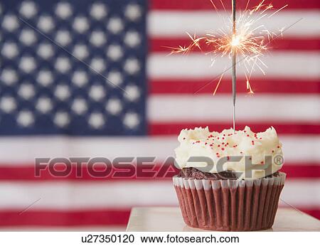 Studio shot of sparkler atop cupcake, american flag in background View Large Photo Image Stock Image - Studio shot of sparkler atop cupcake, american flag in background. Fotosearch