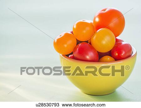 Stock Image - Studio Shot of tomatoes in bowl. Fotosearch