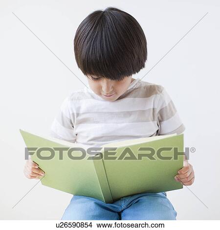 Studio Shot of young boy reading book View Large Photo Image Picture - Studio Shot of young boy reading book. Fotosearch