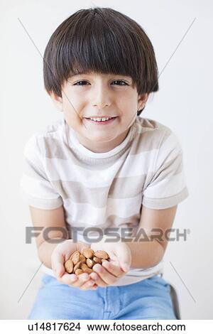 Studio Shot of young boy with almonds View Large Photo Image Picture - Studio Shot of young boy with almonds. Fotosearch