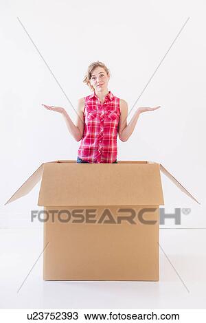Studio shot of young woman inside box View Large Photo Image Stock Image - Studio shot of young woman inside box. Fotosearch