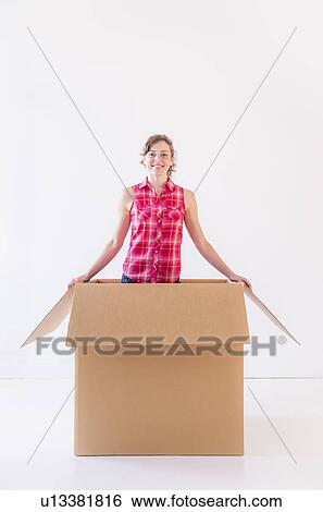 Studio shot of young woman inside box View Large Photo Image Stock Photograph - Studio shot of young woman inside box. Fotosearch