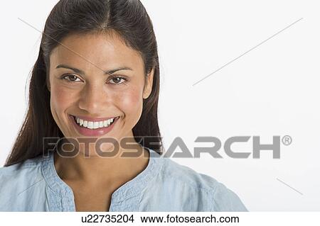 Studio shot of young woman smiling View Large Photo Image Picture - Studio shot of young woman smiling. Fotosearch