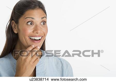 Picture - Studio shot of young woman smiling. Fotosearch