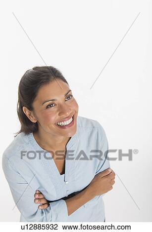 Stock Image - Studio shot of young woman smiling. Fotosearch