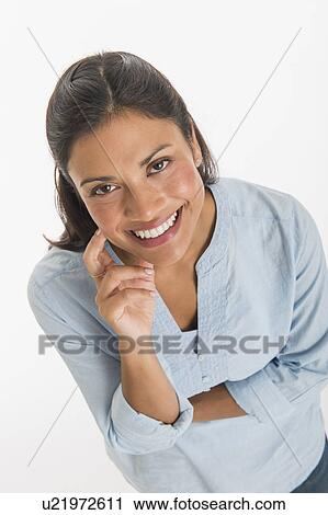 Studio shot of young woman smiling View Large Photo Image Stock Image - Studio shot of young woman smiling. Fotosearch