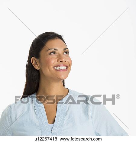 Stock Photo - Studio shot of young woman smiling. Fotosearch