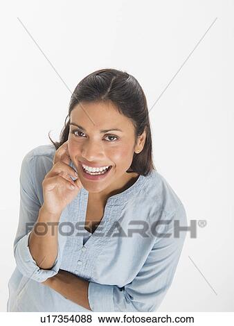 Studio shot of young woman smiling View Large Photo Image Stock Photo - Studio shot of young woman smiling. Fotosearch