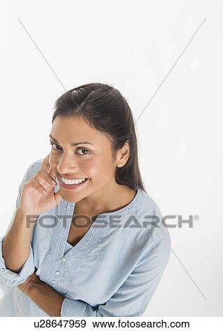 Stock Photo - Studio shot of young woman smiling. Fotosearch