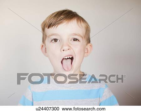 Studio Shot, Portrait of boy sticking out his tounge View Large Photo Image Stock Image - Studio Shot, Portrait of boy sticking out his tounge. Fotosearch