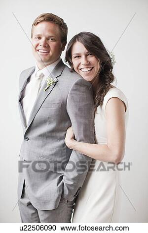 Stock Image - Studio shot, Portrait of married couple. Fotosearch