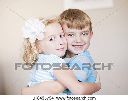 Studio Shot, Portrait of sister and brother hugging each other View Large Photo Image Picture - Studio Shot, Portrait of sister and brother hugging each other. Fotosearch