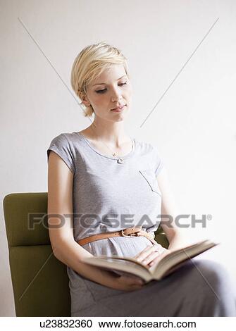 Studio shot, Portrait of sitting woman reading book View Large Photo Image Stock Image - Studio shot, Portrait of sitting woman reading book. Fotosearch