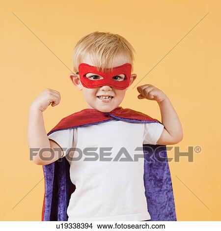 Studio shot, Portrait of smiling boy (2-5 years) showing his strenght View Large Photo Image Picture - Studio shot, Portrait of smiling boy (2-5 years) showing his strenght. Fotosearch