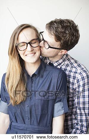 Stock Image - Studio Shot, portrait of young couple. Fotosearch
