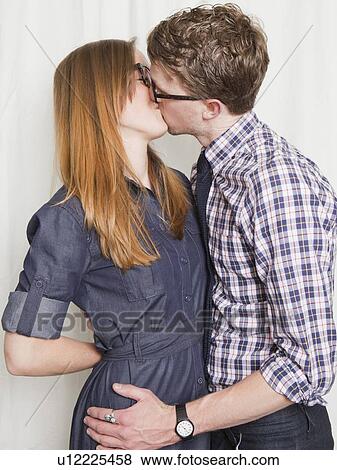 Studio Shot, portrait of young couple kissing View Large Photo Image Stock Photo - Studio Shot, portrait of young couple kissing. Fotosearch