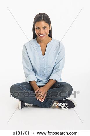 Studio shot woman sitting cross-legged View Large Photo Image Stock Photo - Studio shot woman sitting cross-legged. Fotosearch