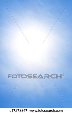 Stock Photo - Sun behind small cloud on blue sky. Fotosearch